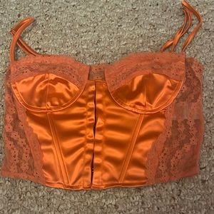 Orange corset top. Worn once. Light wear and fraying on the top.